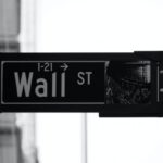 Investment Basics - grayscale photo of Wall St. signage