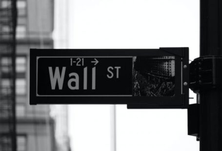 Investment Basics - grayscale photo of Wall St. signage