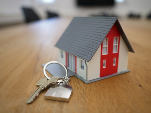 Investment Basics - white and red wooden house miniature on brown table